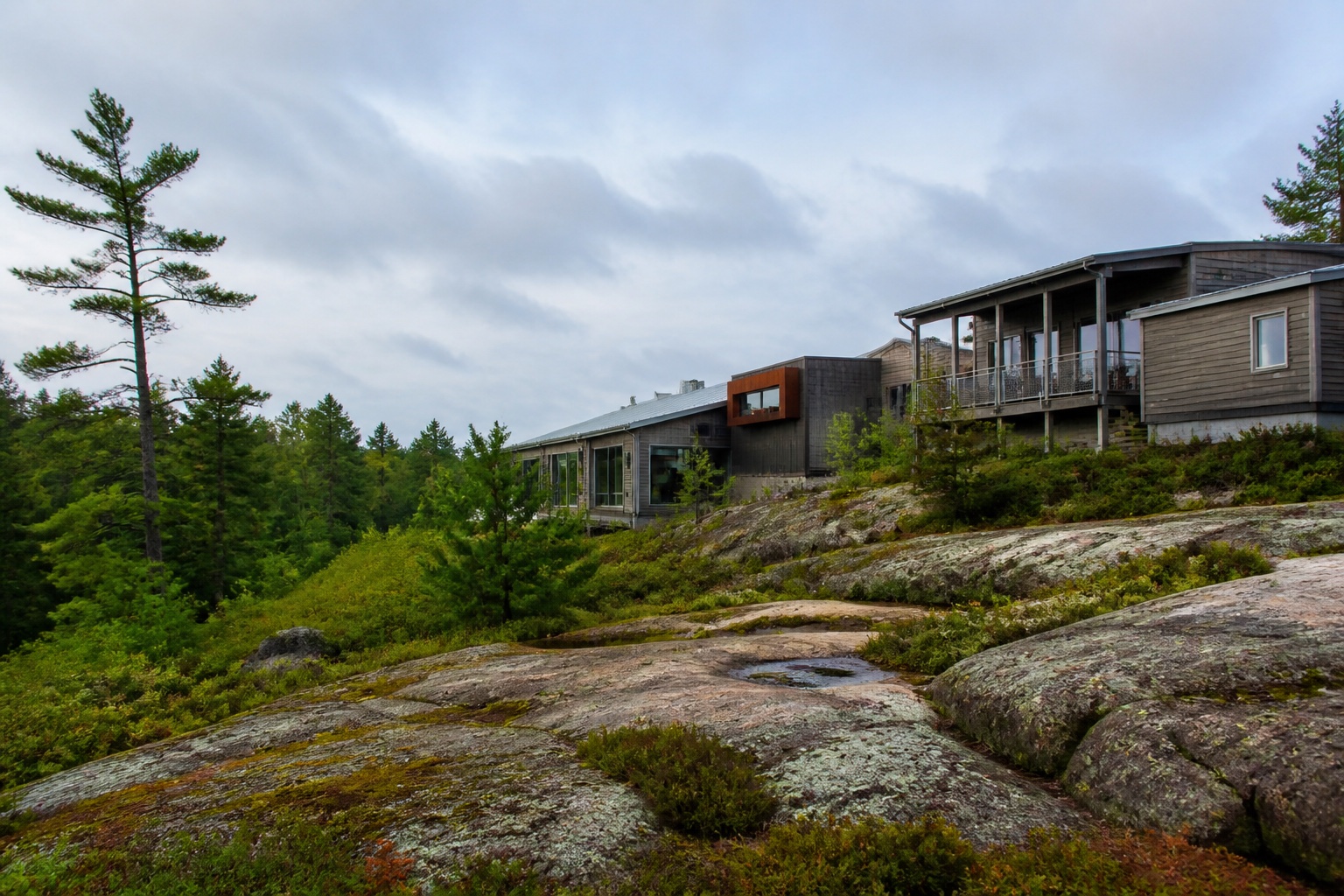 Modern research buildings beside a forested Canadian Shield landscape